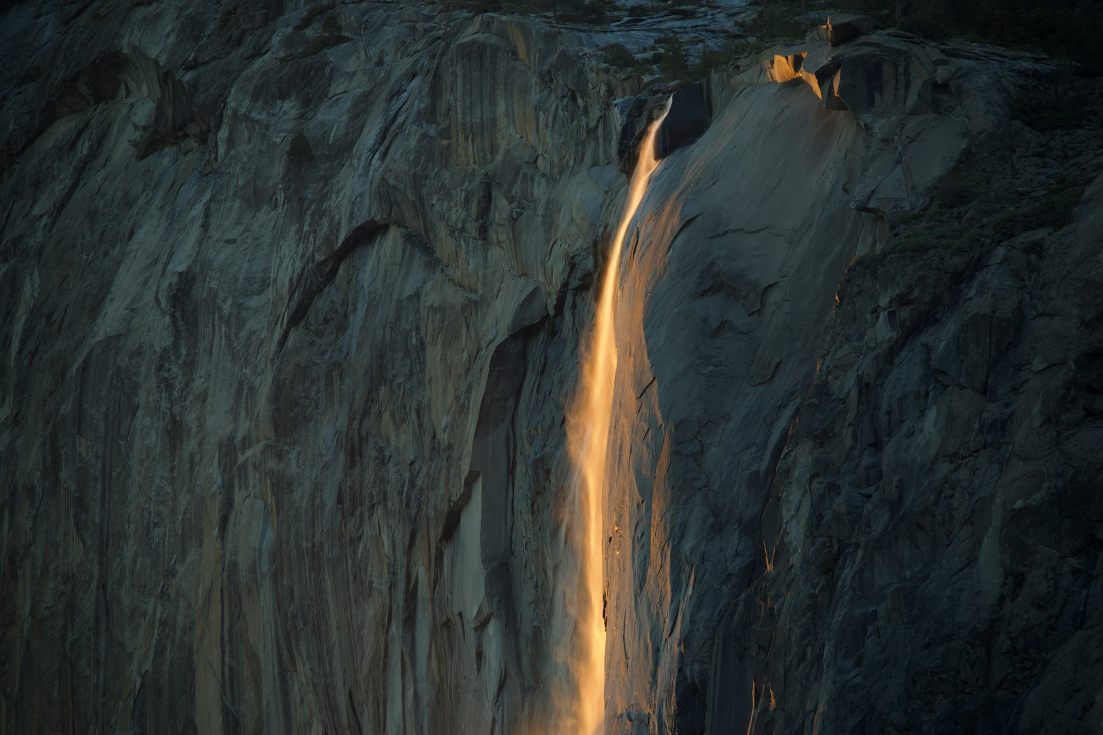 A waterfall with a light coming out of it
