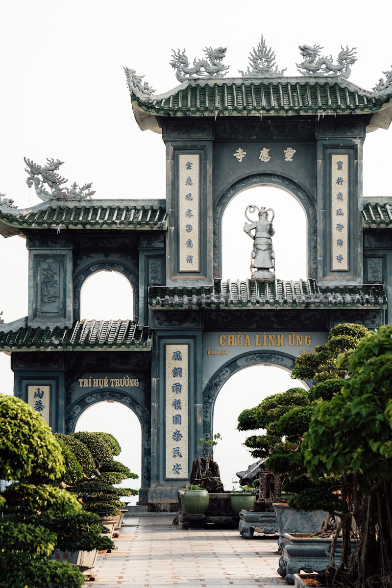 A large gate with a statue on top of it